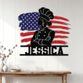 Patriotic woman chef metal sign displayed on a white paneled kitchen wall