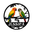 Colorful conure pair perched on a branch in a round bird-themed metal sign design