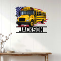 School bus wall decor displayed above a console table in a bright, modern home entryway