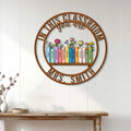 Teacher wall decor displayed on white paneling, showing colorful books and flowers in a classroom-inspired design