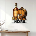 Bourbon bar wall decor displayed above a console table, featuring a whiskey bottle, barrel, glass, and ice