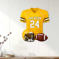 Yellow football jersey metal sign with helmet and football displayed as sports wall decor