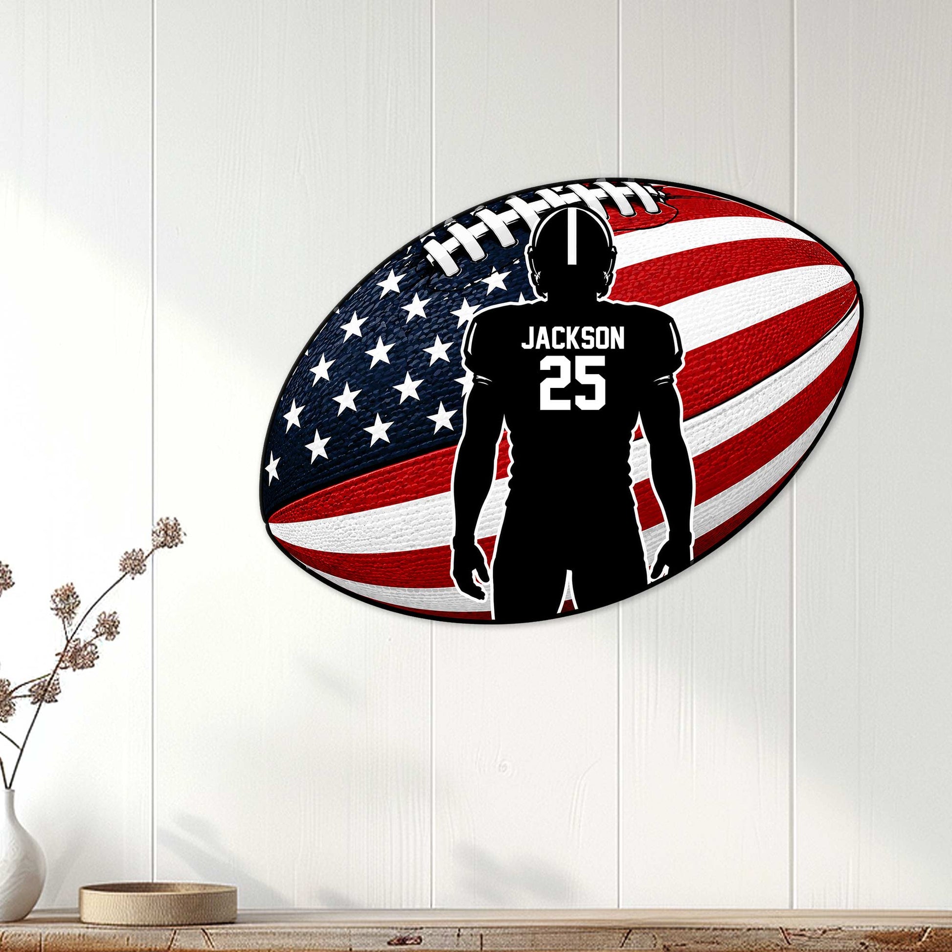 American football wall sign displayed on a light wood-paneled wall in a home interior