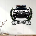 Police car wall sign displayed on a light wood-paneled wall with a bold laurel and banner design