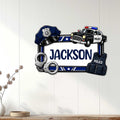 Police-themed metal wall sign displayed on a light wood wall with a badge, patrol car, and law enforcement gear