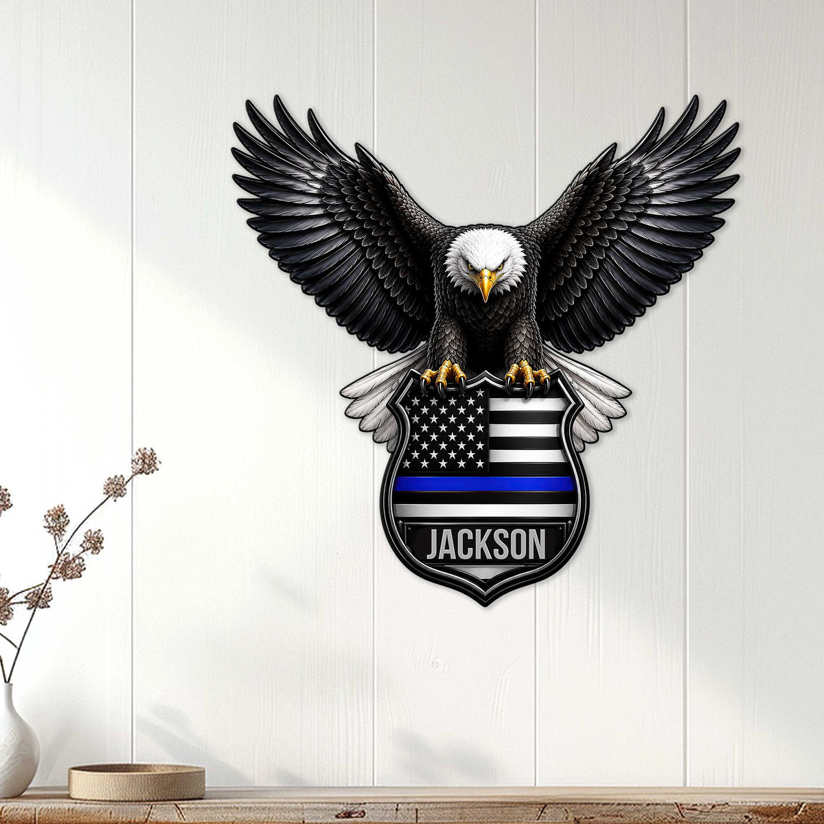 Police wall decor displayed on a white paneled wall, featuring an eagle and thin blue line shield
