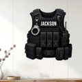 Police vest wall sign displayed on a light wood-paneled wall as law enforcement home decor