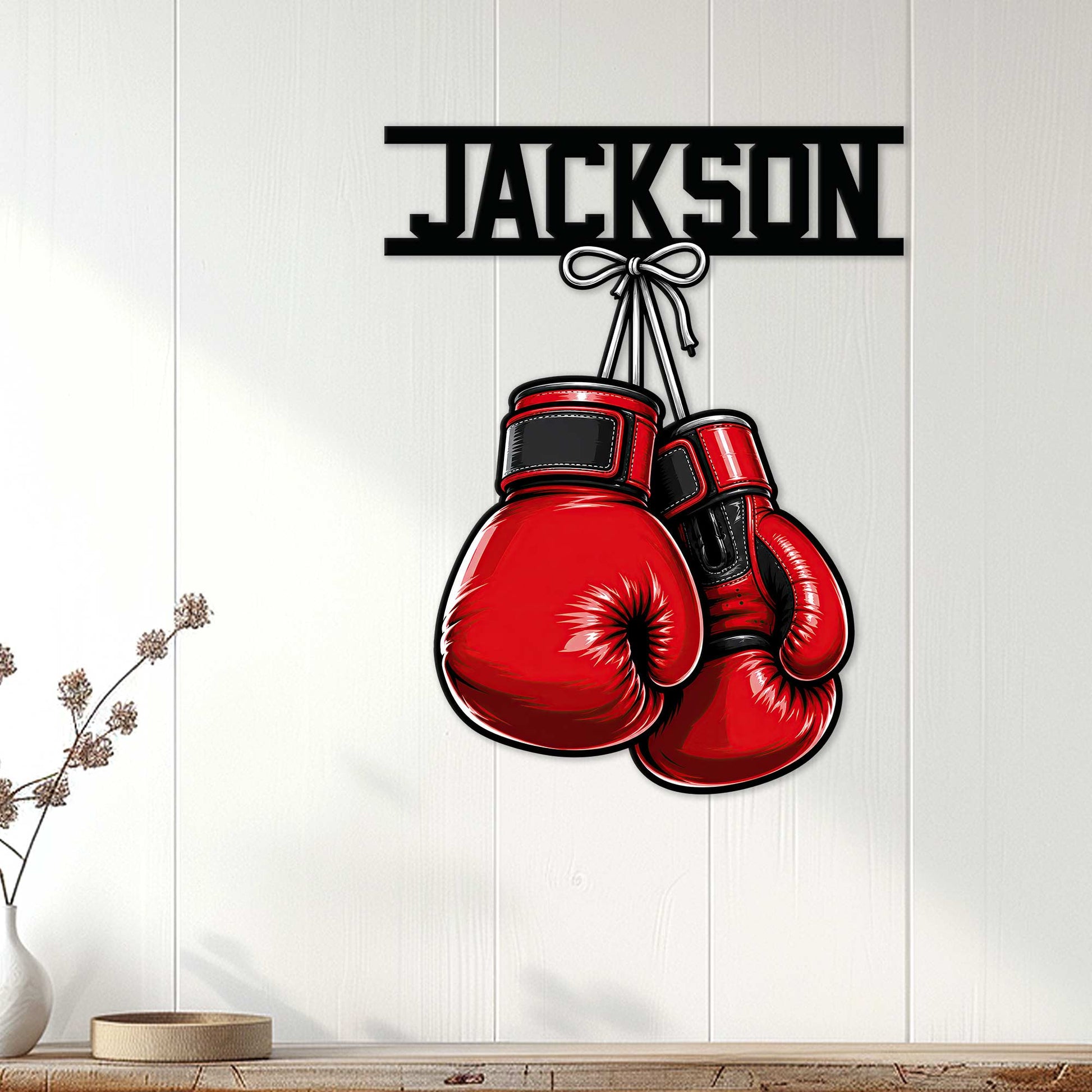 Red boxing gloves wall sign displayed on a light wood-paneled wall in a modern home setting