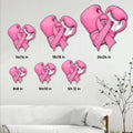 Breast cancer awareness boxing glove sign shown in multiple size options on a living room wall