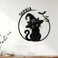 Black cat witch wall sign displayed on a light wood-paneled wall as Halloween decor