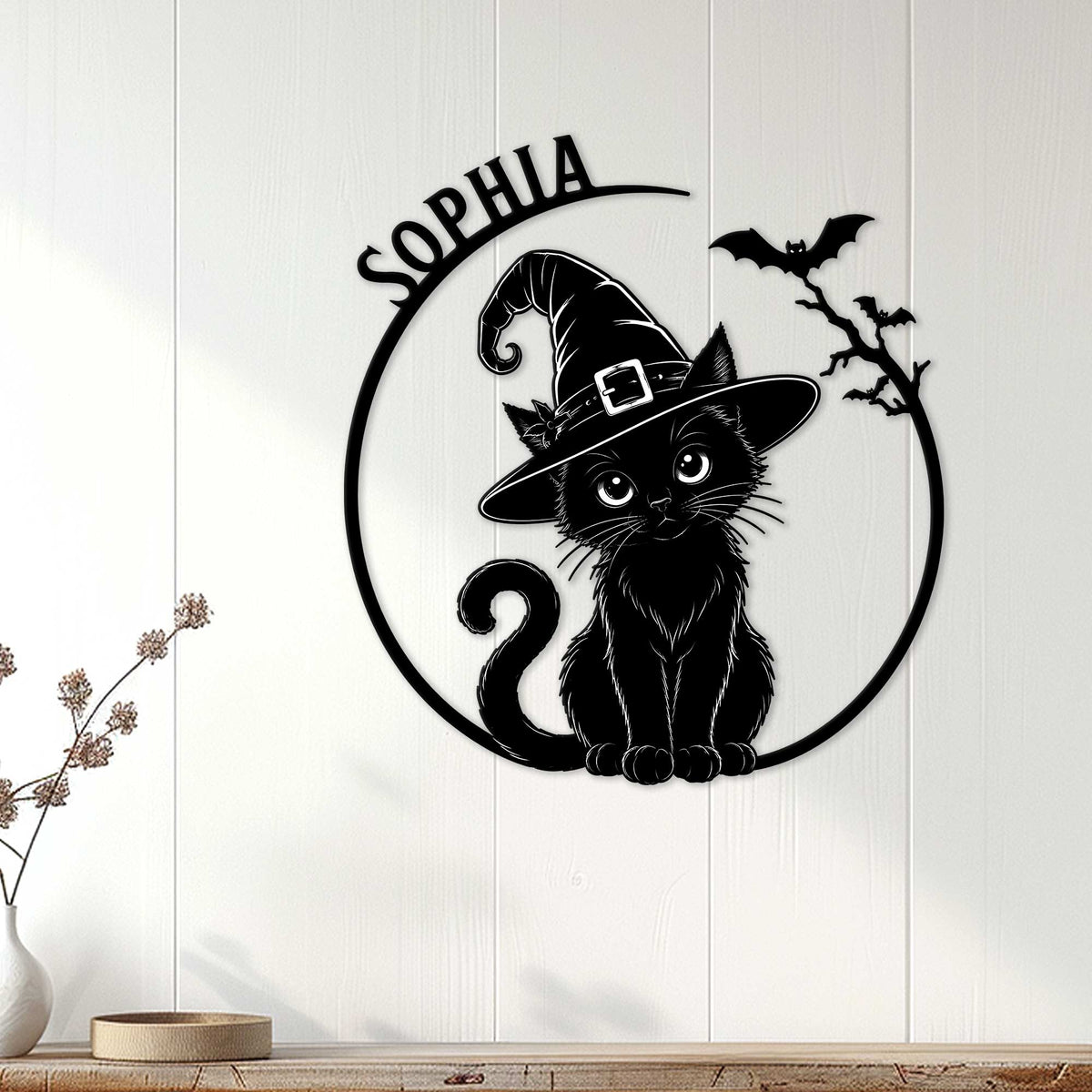 Black cat witch wall sign displayed on a light wood-paneled wall as Halloween decor