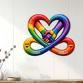 Rainbow LGBTQ+ wall sign displayed on a white paneled wall in a bright home setting