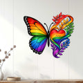 Rainbow butterfly metal wall sign displayed on a light wood-paneled wall as colorful LGBTQ decor