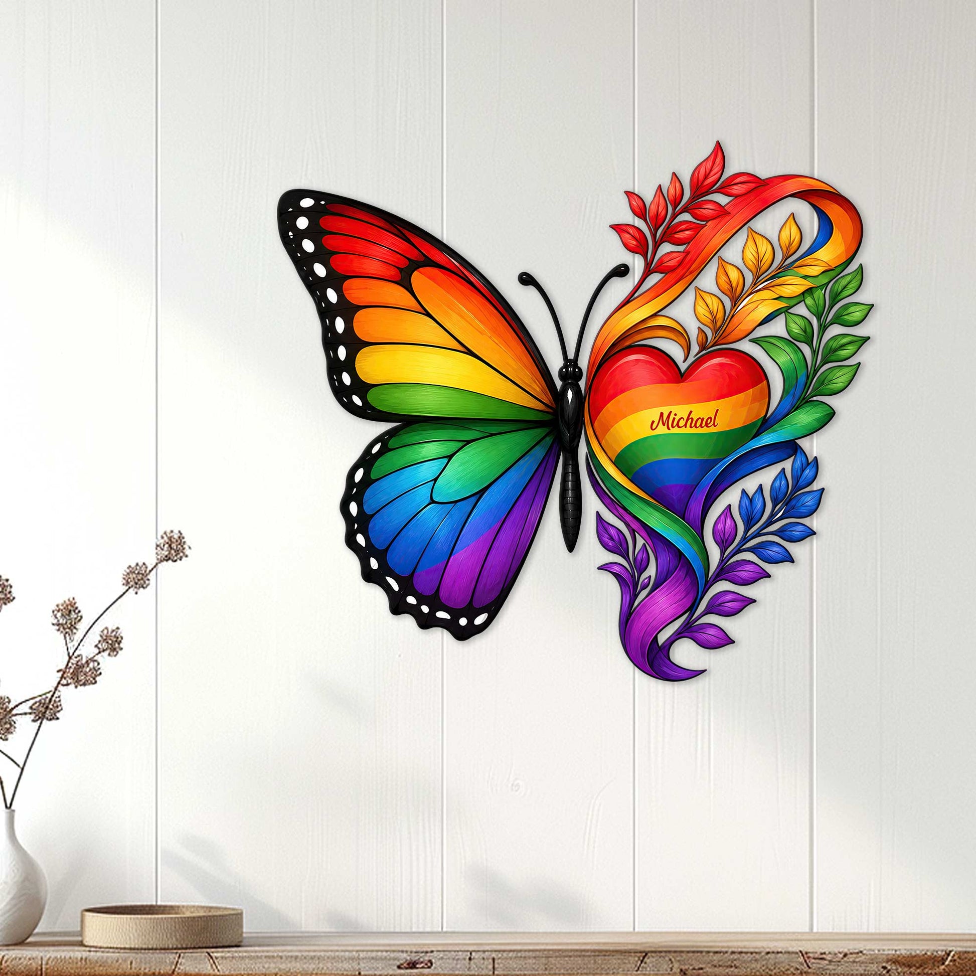 Rainbow butterfly metal wall sign displayed on a light wood-paneled wall as colorful LGBTQ decor