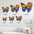 LGBTQ pride butterfly metal sign shown in multiple size options above a modern living room sofa