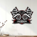 Racing wall decor displayed on a light wood wall, featuring twin turbochargers and crossed checkered flags