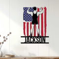 Wrestling wall decor displayed on white wood paneling, featuring a flexing wrestler and American flag design