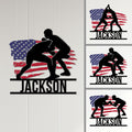 Wrestling metal sign displayed on a light wall alongside alternate grappling silhouette styles