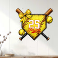 Softball player wall decor displayed on a light paneled wall, featuring crossed bats and a bright softball shield