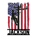 Patriotic lineman metal sign featuring a utility worker climbing a power pole over an American flag