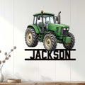 Green tractor metal wall sign displayed on white paneled home decor above a console table