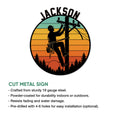 Lineman cut metal sign with a utility worker silhouette, sunset scene, and installation feature details