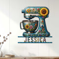 Floral stand mixer baking sign displayed on a bright paneled wall above a console table