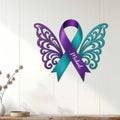 Winged purple and teal suicide prevention ribbon sign displayed as meaningful wall decor in a home