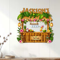 Tropical tiki bar wall sign displayed on a light wood wall as colorful home bar decor