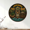 Tropical tiki bar wall sign displayed on a light paneled wall above a console table