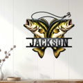 Custom bass fishing metal sign displayed as wall decor on a light wood-paneled wall