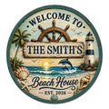 Round beach house metal sign with a nautical wheel, lighthouse, palm trees, dolphins, shells, and ocean scene