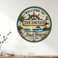 Coastal beach house metal sign displayed on a white paneled wall above a console table