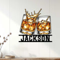Bourbon wall sign displayed in a bright home interior with two whiskey glasses and amber splash artwork