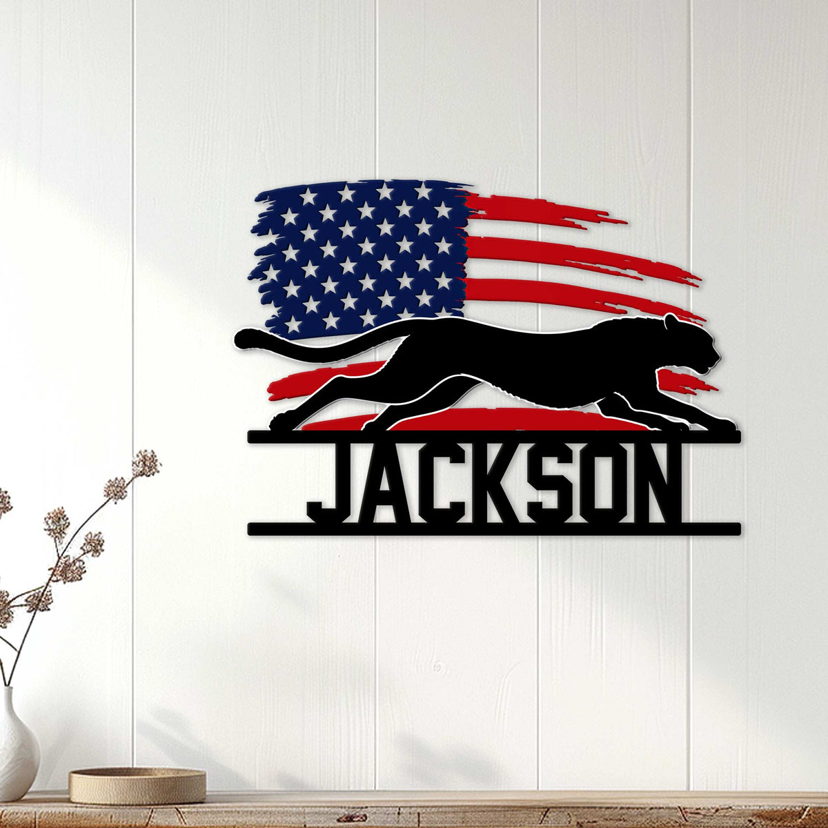 Patriotic cheetah metal sign displayed as bold wall decor on a light wood-paneled wall