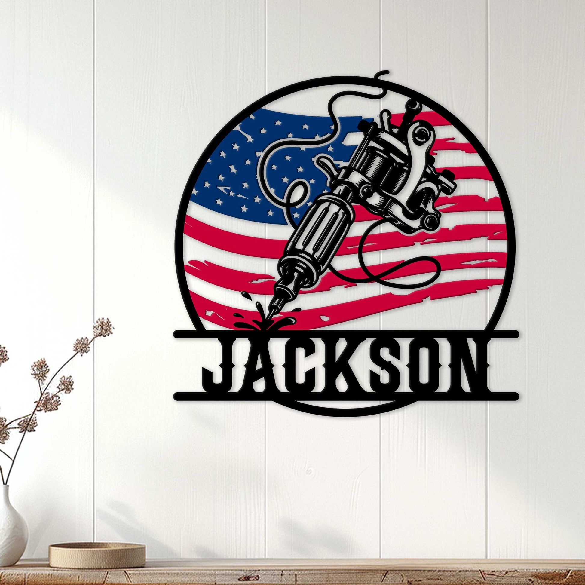 Patriotic tattoo artist wall sign displayed on a white paneled wall in a home interior
