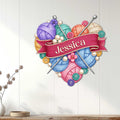 Knitting metal sign displayed on a light wood-paneled wall above a console table