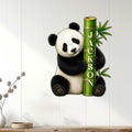 Panda wall sign displayed on a light wood-paneled wall in a welcoming home interior