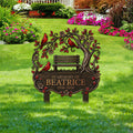 Cardinal remembrance garden sign displayed outdoors among colorful flowers and green lawn