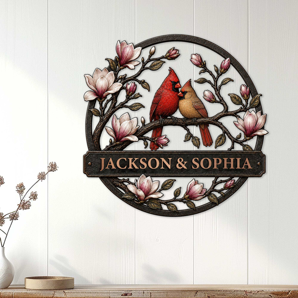 Cardinal and magnolia metal wall sign displayed on a light paneled wall in a home setting