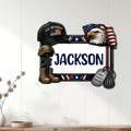 Patriotic veteran wall sign mounted on a light wood-paneled wall with eagle, flag, helmet, boots, and dog tags