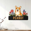 Floral corgi metal sign displayed as cheerful wall decor on a light wood-paneled interior wall