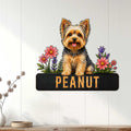 Yorkie dog metal wall sign displayed on a light wood-paneled wall with floral artwork