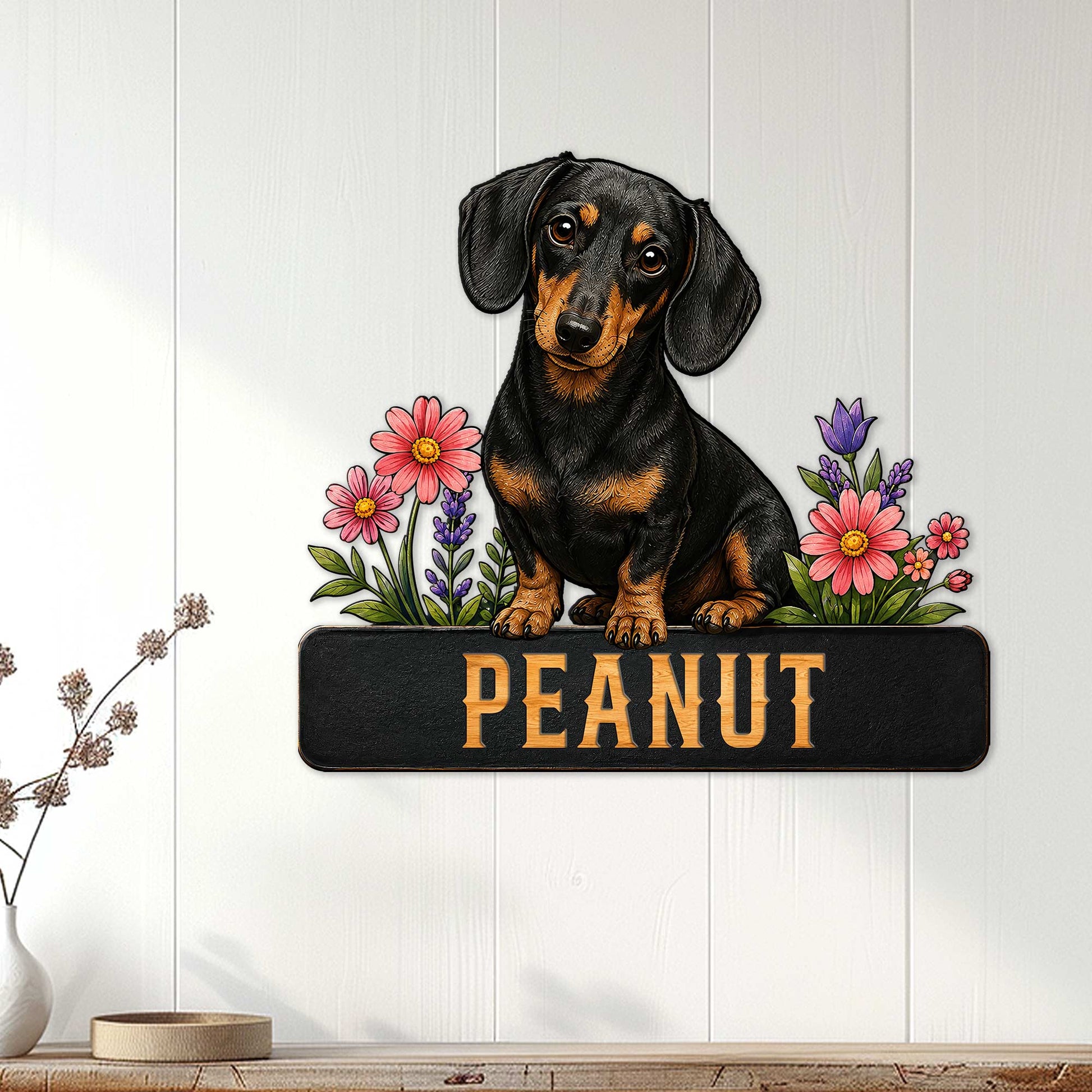 Dachshund wall sign displayed on a light wood-paneled wall with a black and tan dog and flowers