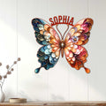 Decorative butterfly metal wall sign displayed on a light wood-paneled wall in a bright room