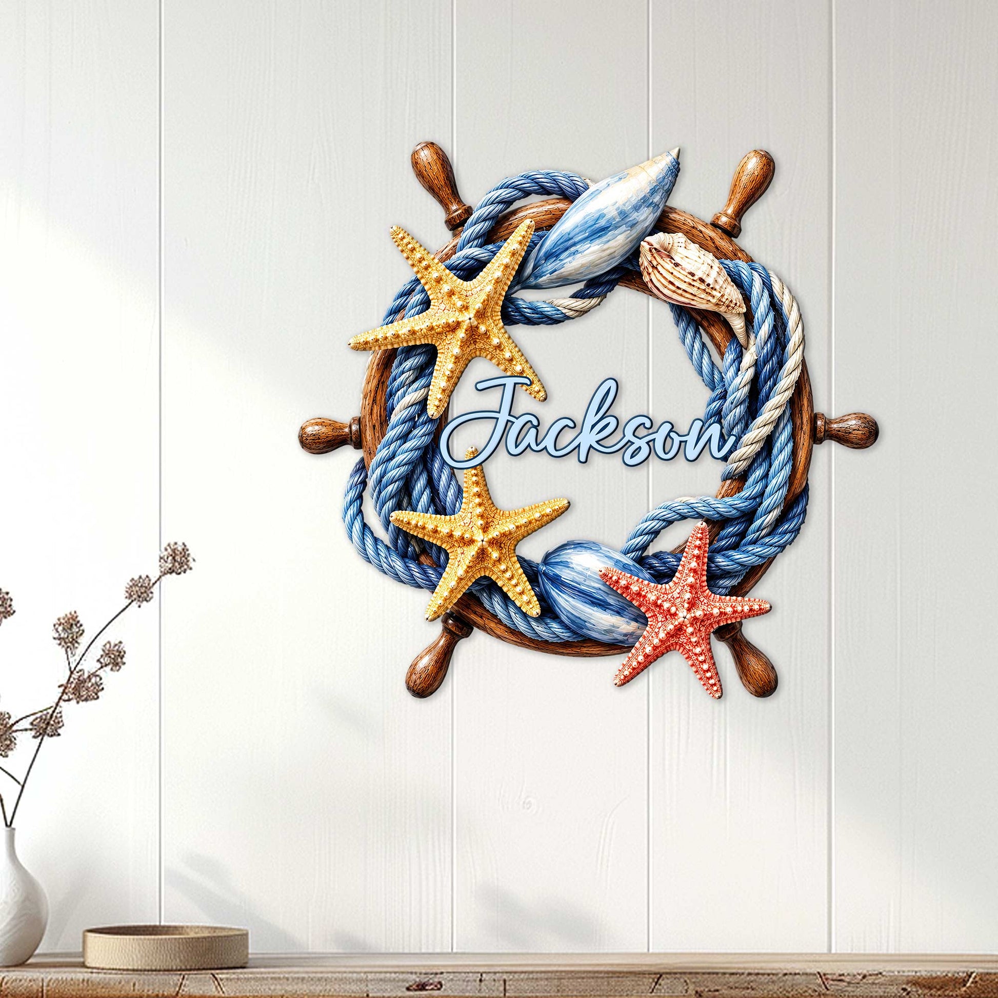 Nautical ship wheel wall sign displayed on a white paneled wall in a bright coastal home
