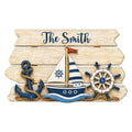 Custom nautical metal sign with a sailboat, anchor, ship wheel, rope, and weathered coastal wood design