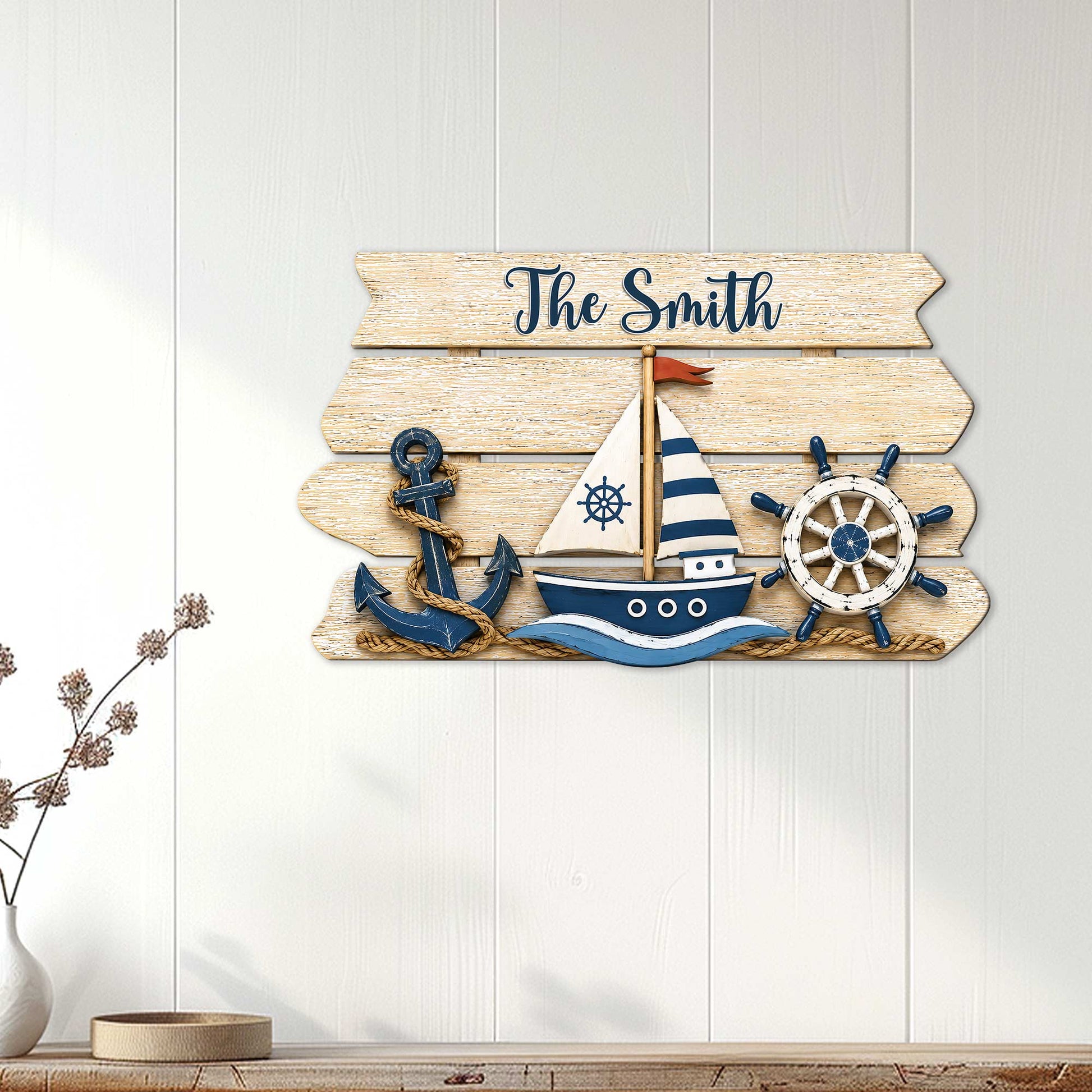 Nautical family metal sign displayed on a light wood wall with sailboat, anchor, and ship wheel artwork