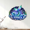 Mermaid ocean wall decor displayed on a light wood wall above a console table in a coastal room