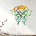 Jeweled butterfly wall decor displayed on a light wood-paneled wall in a bright, modern living space